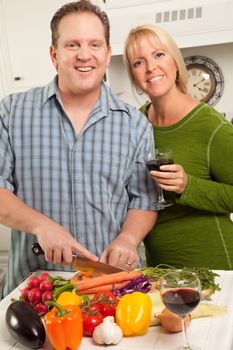 Happy Couple Enjoying An Evening Preparing Food in the Kitchen.