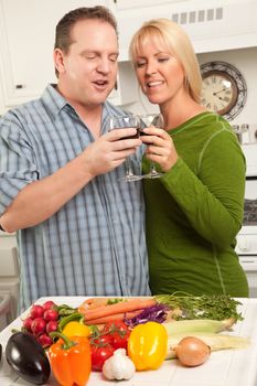 Happy Couple Enjoying An Evening Preparing Food in the Kitchen.