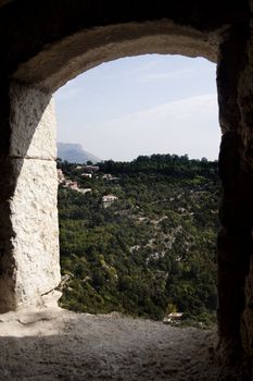 A view of the mountains through a stone archway 