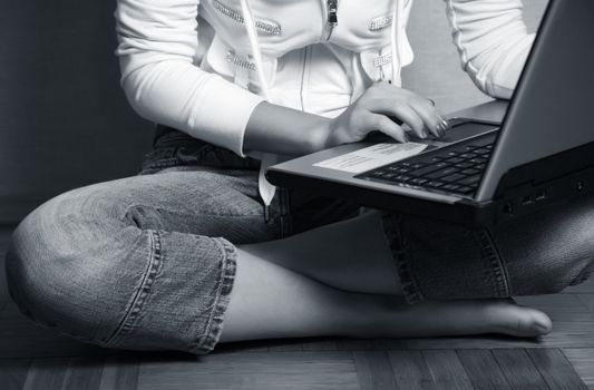 Computer in a lap the young girl