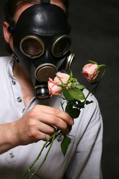 The man in a gas mask with flowers
