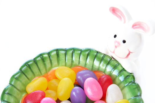 Close up of jelly beans in a candy dish isolated on a white background with copy space.