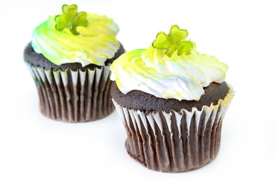 Two cupcakes decorated for St Patricks Day and isolated on a white background.