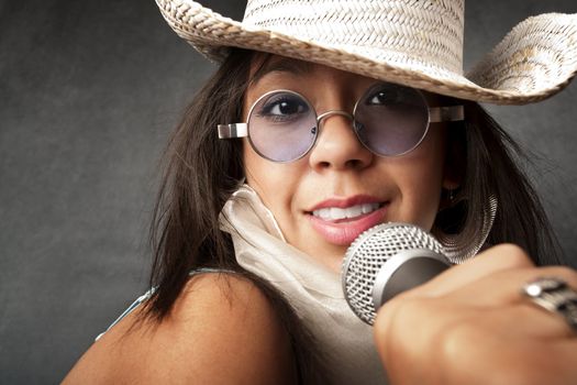 Pretty young singer with a large microphone