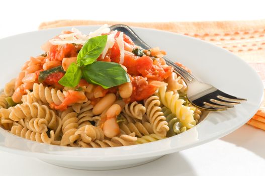 Bowl of rotini pasta with a homemade tomato and bean sauce.