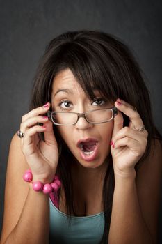 Close up portrait of a pretty brunette woman gasping in shock