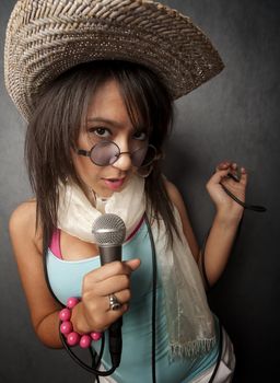 Pretty young singer with a large microphone