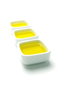 Olive Oil in small serving bowls isolated against a white background