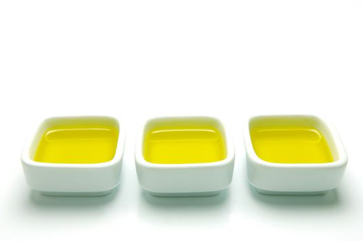 Olive Oil in small serving bowls isolated against a white background
