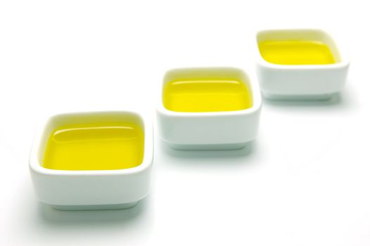 Olive Oil in small serving bowls isolated against a white background