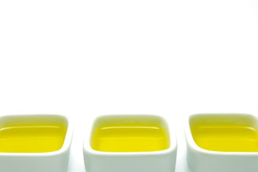 Olive Oil in small serving bowls isolated against a white background