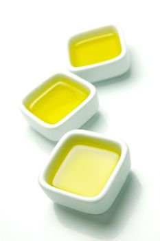 Olive Oil in small serving bowls isolated against a white background