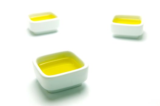 Olive Oil in small serving bowls isolated against a white background