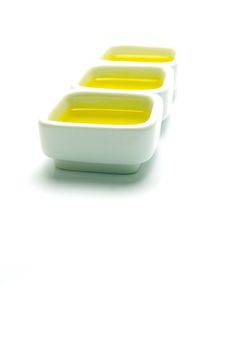 Olive Oil in small serving bowls isolated against a white background