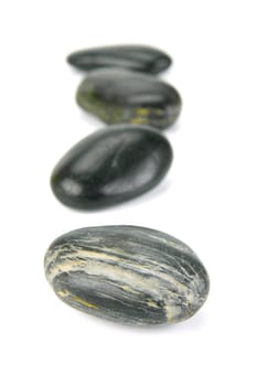 Black river rocks isolated against a white background