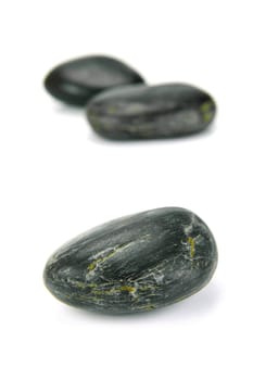 Black river rocks isolated against a white background