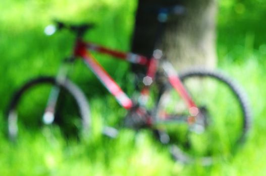 mountain bike in green nature out of focus can be used as background
