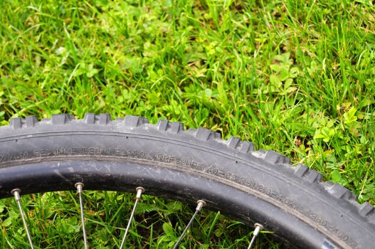 mountain bike offroad tire in green grass showing sport in nature concept