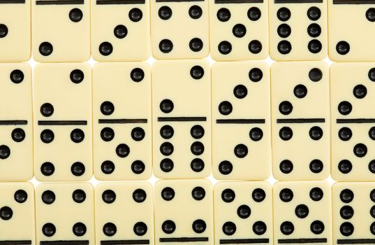 Background from white spotted dominoes pieces