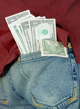 Green dollars in hip pocket on jeans