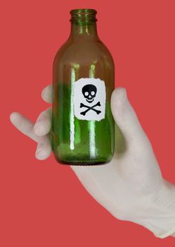Green bottle with skull and crossbones on hand