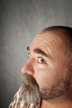Profile closeup of a man in his forties with mustache