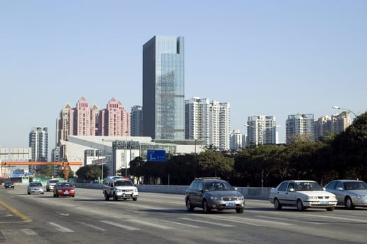 China, Shenzhen city - general cityscape with modern office building, residential buildings and street.