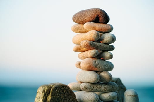 Pile of pebbles in the balance on the seacoast