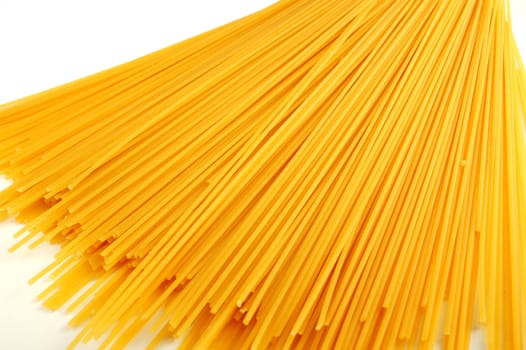 Dried spaghetti closeup over a white background
