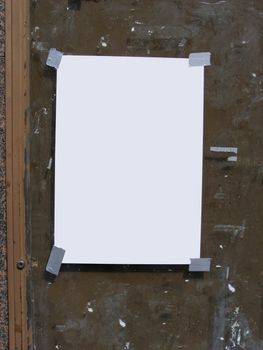 Blank notice taped to a grunge background 