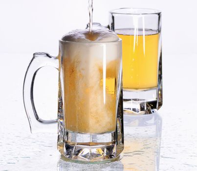 Two mugs with beer on a table