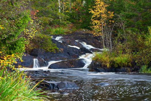 mountain waterfall. fast stream water. autumn landscape