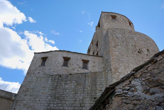 Towers in old town in Mostar, Bosnia and Herzegovina with blue sky in background.