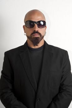 blacks man with glasses, beard and black jacket, bouncer bodyguard