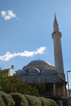 Karadjozbeg Mosque in Mostar, Bosnia and Herzegovina with blue sky in background.