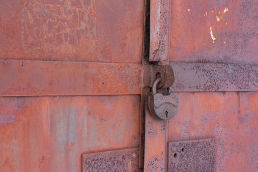 Rusty iron gates locked on old lock