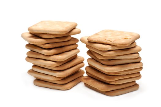 Crackers put by pile on white background