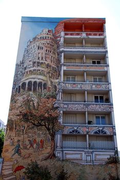 One of the many painted buildings in Lyon, in France. Indeed in Lyon there are many buildings painted like this with many different drawings. They paint this like a normal picture but on the walls of big buildings. In this one It is represented many things but we can see the tower of Pise in Italy.