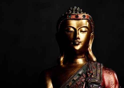 Golden Buddha statue on a dark background