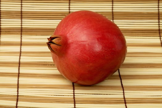 The pomegranate on the wooden mat background