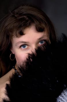 Portrait of the girl with a fan in hand