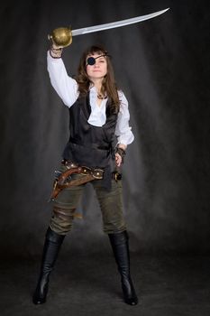 The girl - pirate with a sabre in hands and eye patch on face