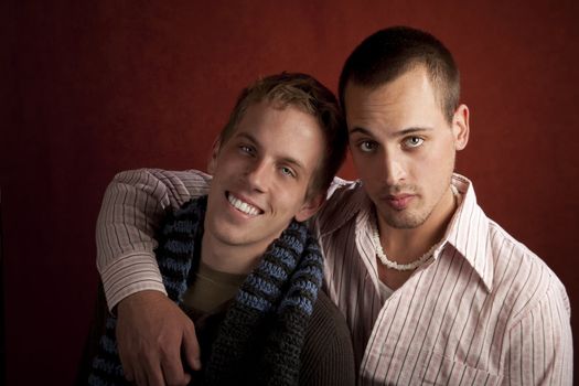 Portrait of two young men embracing in studio