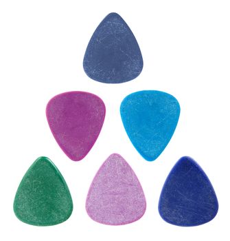 Triangle made of colourful guitar picks, isolated on white.