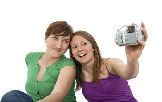 Two young women taking a self-portrait with a digital camera.