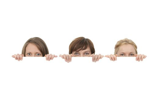 Three young women behind a blank banner ad, on white background.