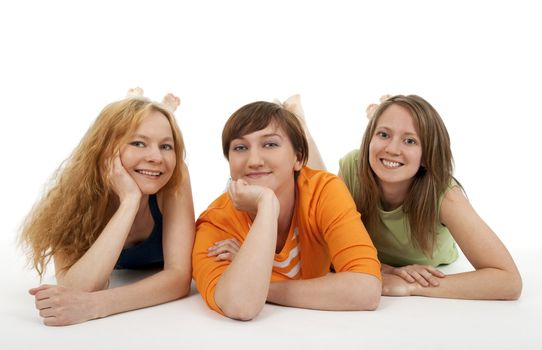 Three smiling friends looking into the camera, relaxing.