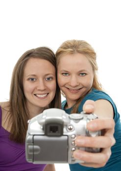 Two pretty girls posing for a camera and having fun.