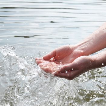 hand and splashing cold drink water showing nature concept