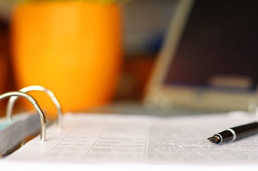 business desktop still life with folder pen copyspace and laptop in office